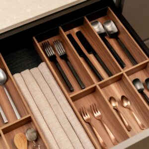 a drawer with utensils and spoons in it